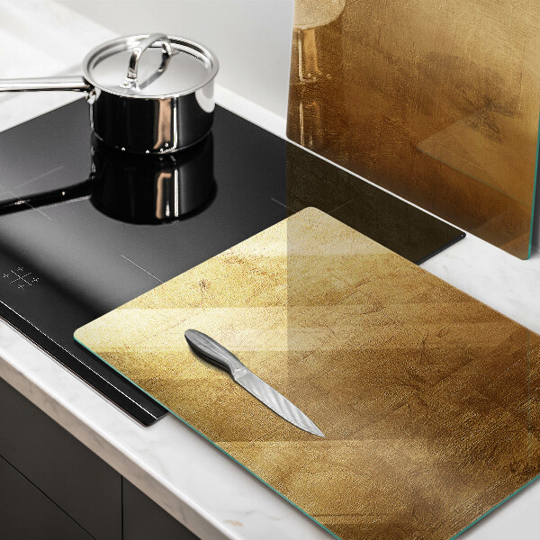 Glas Herdabdeckplatte Goldbeschaffenheitshintergrund