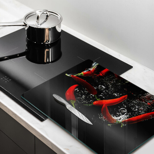 Glas Herdabdeckplatte Chilischoten in Wasser