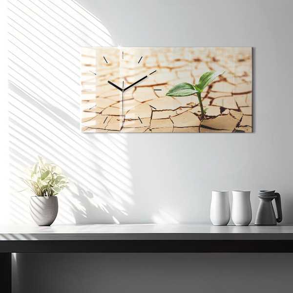 Horizontale Uhr mit motiv Pflanze in getrockneter Erde