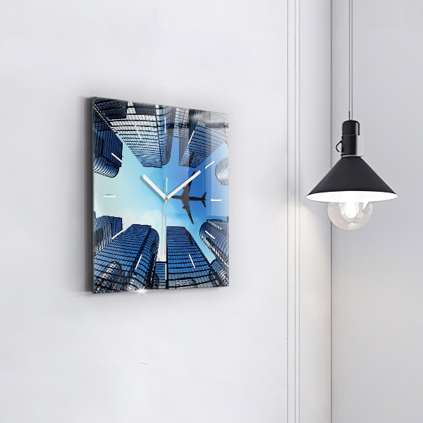 Wanduhr quadratisch mit motiv Flugzeug über Gebäuden