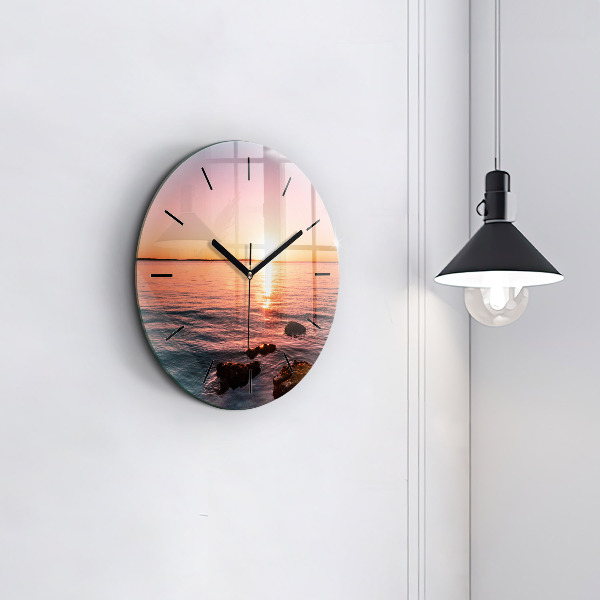 Wanduhr glas rund Felsen bei Sonnenuntergang