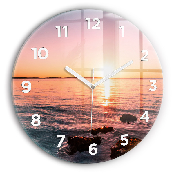 Wanduhr glas rund Felsen bei Sonnenuntergang